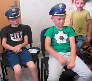 Dwóch chłopców w policyjnych czapkach