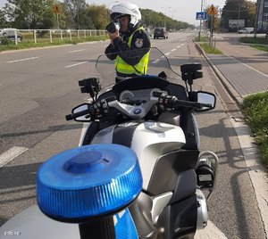 Policjant i motocykl prowadzący pomiar prędkości na drodze
