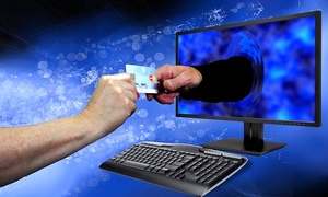 Ręce przekazujące pieniądze nad klawiaturą komputerową