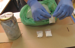 Zabezpieczone przez policjantów narkotyki w słoiku i torebkach