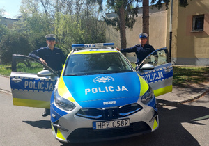 Policjanci drogówki przy radiowozie