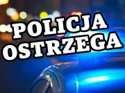 Niebieskie światła i napis Policja ostrzega