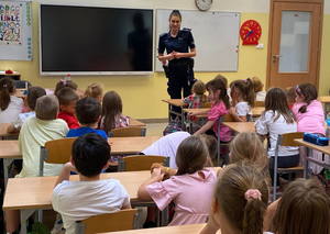 policjantka z uczniami w sali