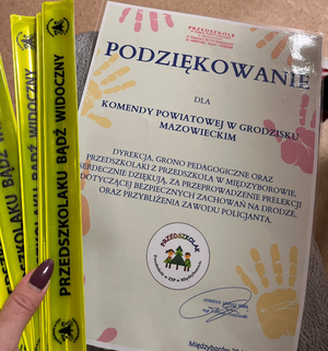 Dyplom i opaski z napisem